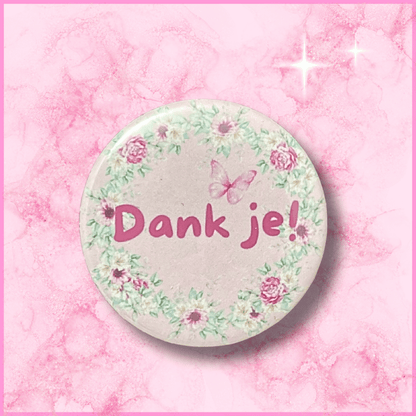 Voorkant van een ronde fotomagneet (38mm) met een bedankje erop (Dank je!)